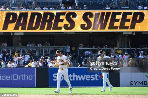 Tyler Wade of the San Diego Padres, left, and Bryce Johnson run off the field after the Padres beat the Washington Nationals 8-5 in a baseball game...