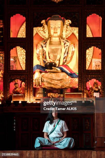 young woman meditating at the temple - nepal temple stock pictures, royalty-free photos & images