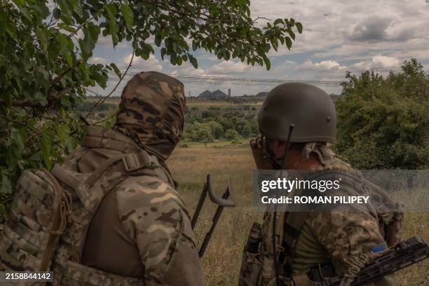 Ukrainian military servicemen look on towards the town of Toretsk, eastern Donetsk region, on June 25 amid the Russian invasion of Ukraine. Compared...