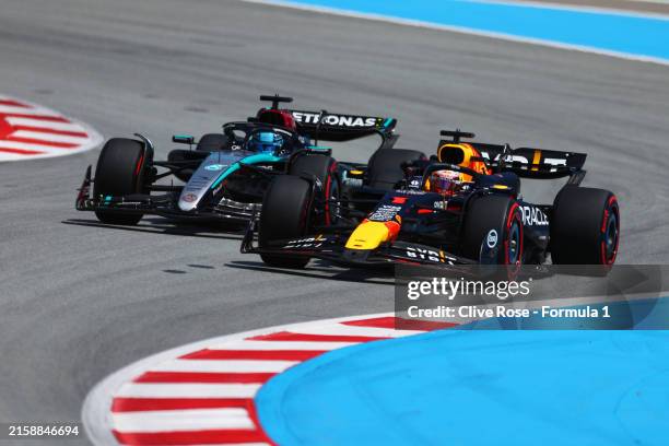 Max Verstappen of the Netherlands driving the Oracle Red Bull Racing RB20 overtakes George Russell of Great Britain driving the Mercedes AMG Petronas...
