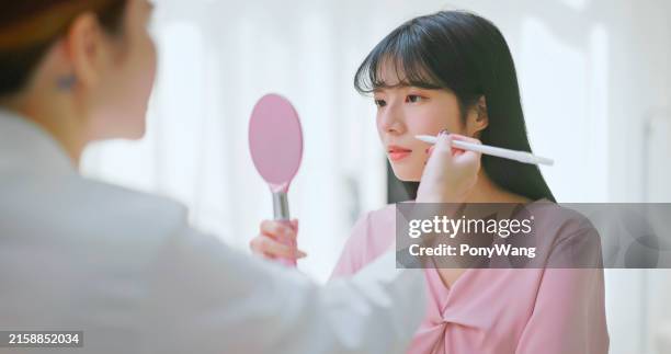 female doctor skin marker explain - plastic hand mirror stock pictures, royalty-free photos & images