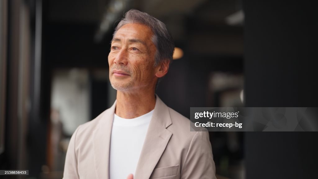 Portrait of handsome senior adult Asian businessman