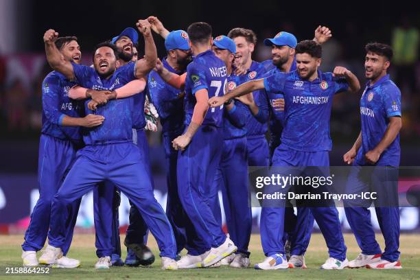 Gulbadin Naib of Afghanistan celebrates with teammates after dismissing Tim David of Australia during the ICC Men's T20 Cricket World Cup West Indies...