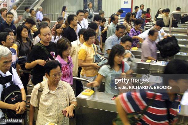People from Hong Kong exit the Lowu MTR station for the border crossing immigration desks, 23 September 2003, to cross into mainland China. A chief...