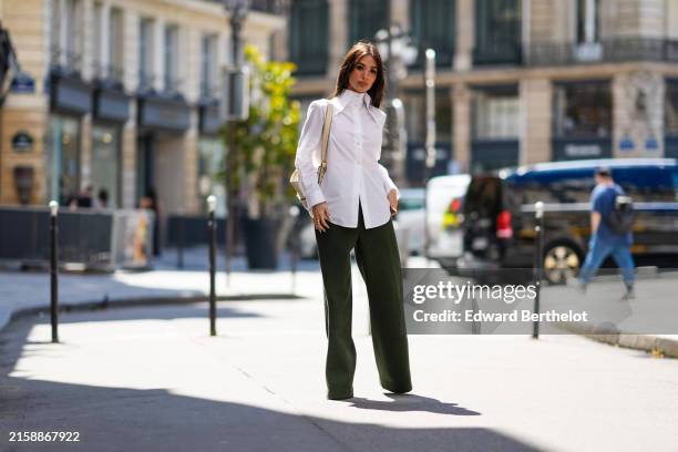 Heart Evangelista wears a white button up long sleeve shirt, a beige Chloe leather bag with gold hardware, diamond bracelet, gold Cartier bracelet,...