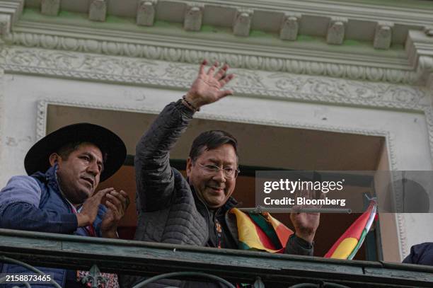 Luis Arce, Bolivias president, waves to demonstrators from the balcony at Palacio Quemado in La Paz, Bolivia, on Wednesday, June 26, 2024. Arcelate...