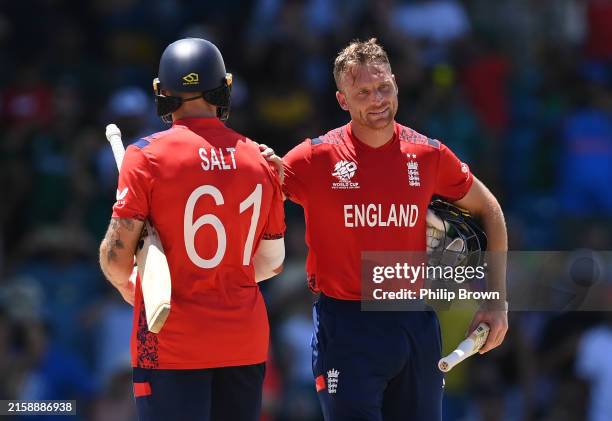 Jos Buttler and Phil Salt of England react after winning the ICC Men's T20 Cricket World Cup West Indies & USA 2024 Super Eight match between USA and...