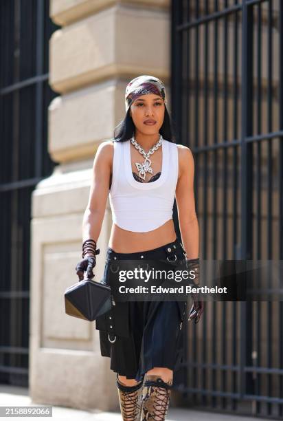 Aleali May wears Harley Davison pattern.print scarf, a giant silver chain with diamond studded butterfly pendant, white cropped tank top, black lace...
