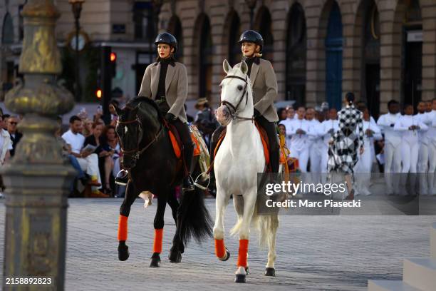 Kendall Jenner and Gigi Hadid ride horses on the runway during Vogue World: Paris at Place Vendome on June 23, 2024 in Paris, France.