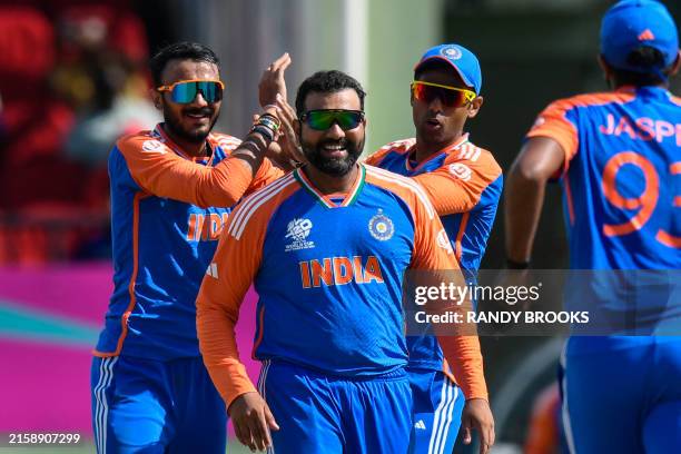Axar Patel , Suryakumar Yadav and Rohit Sharma of India celebrate the dismissal of Jos Buttler of England during the ICC men's Twenty20 World Cup...