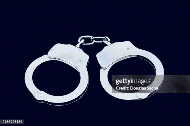 closed and locked handcuffs - open prison cell stock pictures, royalty-free photos & images