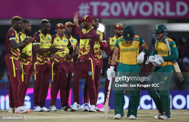 Andre Russell of West Indies celebrates with teammates afte a DRS review to successfully dismiss Reeza Hendricks of South Africa the ICC Men's T20...