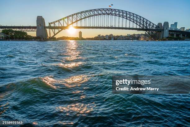 sydney harbour bridge and waves at dusk - sydney harbor stock pictures, royalty-free photos & images