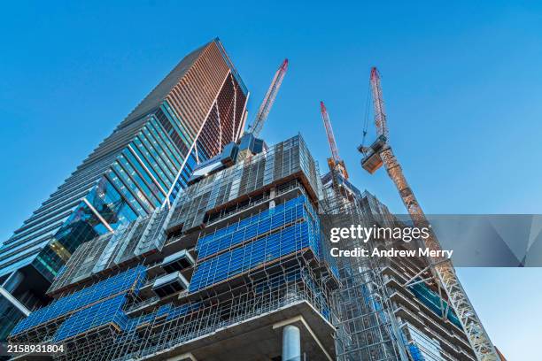 luxury apartment construction, office buildings, blue sky - baustelle stock-fotos und bilder
