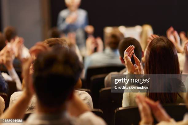 back view of crowd of people applauding on a seminar in convention center. - press conference stock pictures, royalty-free photos & images