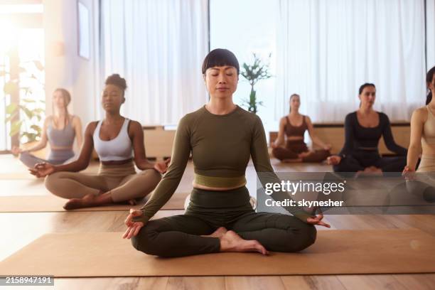 sukasana exercises in yoga studio! - lotus position stock pictures, royalty-free photos & images