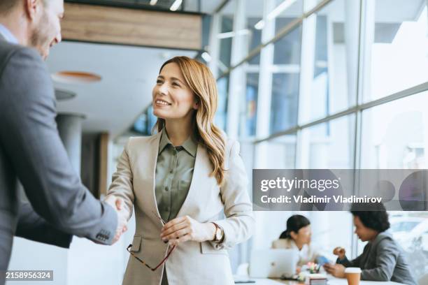 conversation between colleagues in office - regisseur stockfoto's en -beelden
