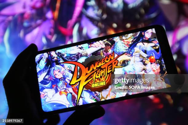 In this photo illustration, a Dungeon Fighter logo of an online game is seen on a smartphone screen.