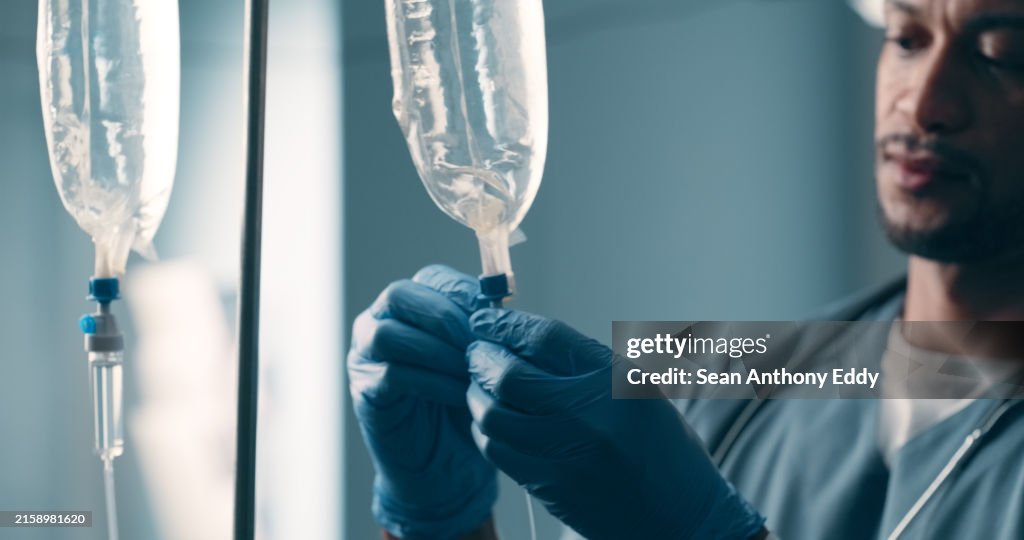 Hospital, iv drip medicine and doctor with gloves, healthcare and wellness with cure, results and liquid injection bag. Person, medical and professional with fluid infusion treatment and anesthesia