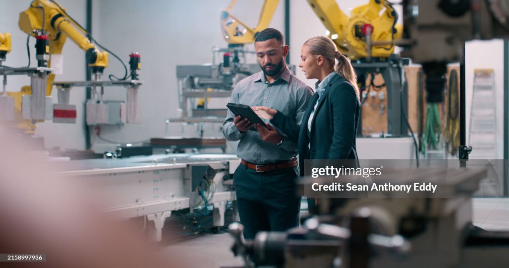 Robotics, staff and tablet engineer inspection with industrial teamwork and check in warehouse. Factory, engineering and futuristic work of manufacturing management with discussion for cnc automation