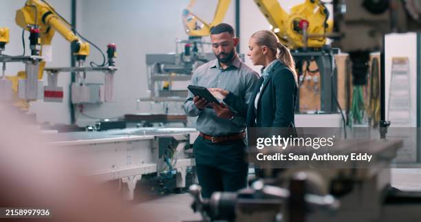 robotics, staff and tablet engineer inspection with industrial teamwork and check in warehouse. factory, engineering and futuristic work of manufacturing management with discussion for cnc automation - fabrik bildbanksfoton och bilder