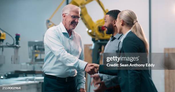 robotics, handshake and engineering team in factory for manufacturing agreement or industry 4.0 collaboration. senior business man or automation technician shaking hands for innovation of cnc machine - robotics stock pictures, royalty-free photos & images