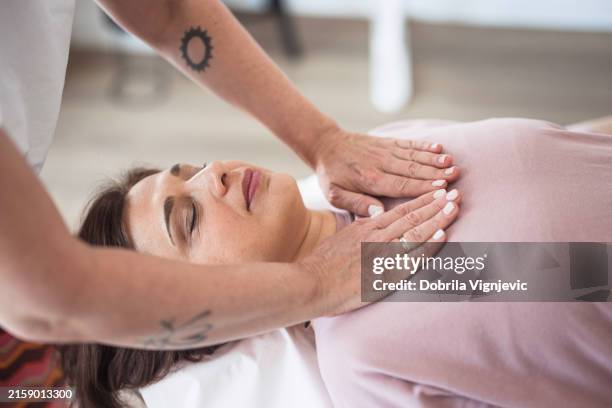 reiki therapist healing a patient - witch doctor tattoo stock pictures, royalty-free photos & images