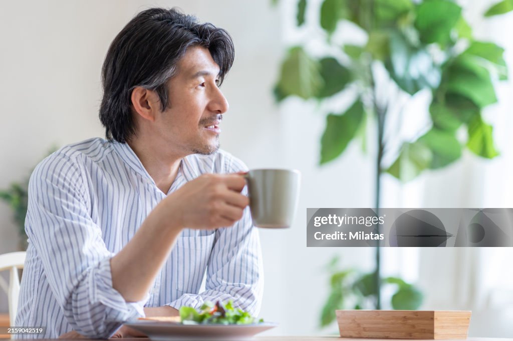 Portrait of a man eating breakfast