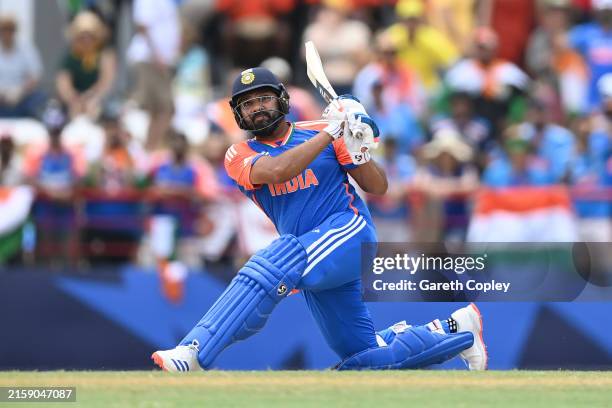 India captain Rohit Sharma hits six runs during the ICC Men's T20 Cricket World Cup West Indies & USA 2024 Super Eight match between Australia and...