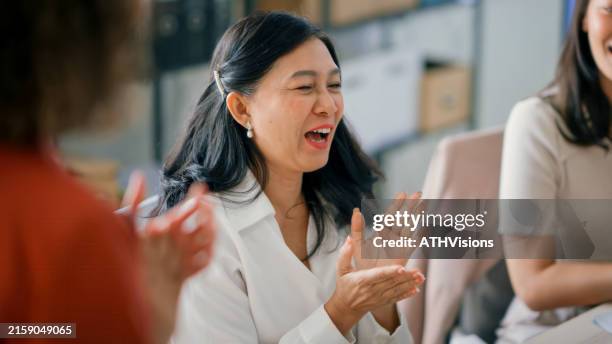 team celebrating success with high-five in modern office - happy colleagues doing team building activity imagens e fotografias de stock