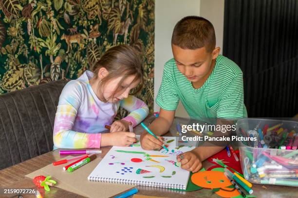 two kids engaged in creative drawing at home - draw pic stock pictures, royalty-free photos & images