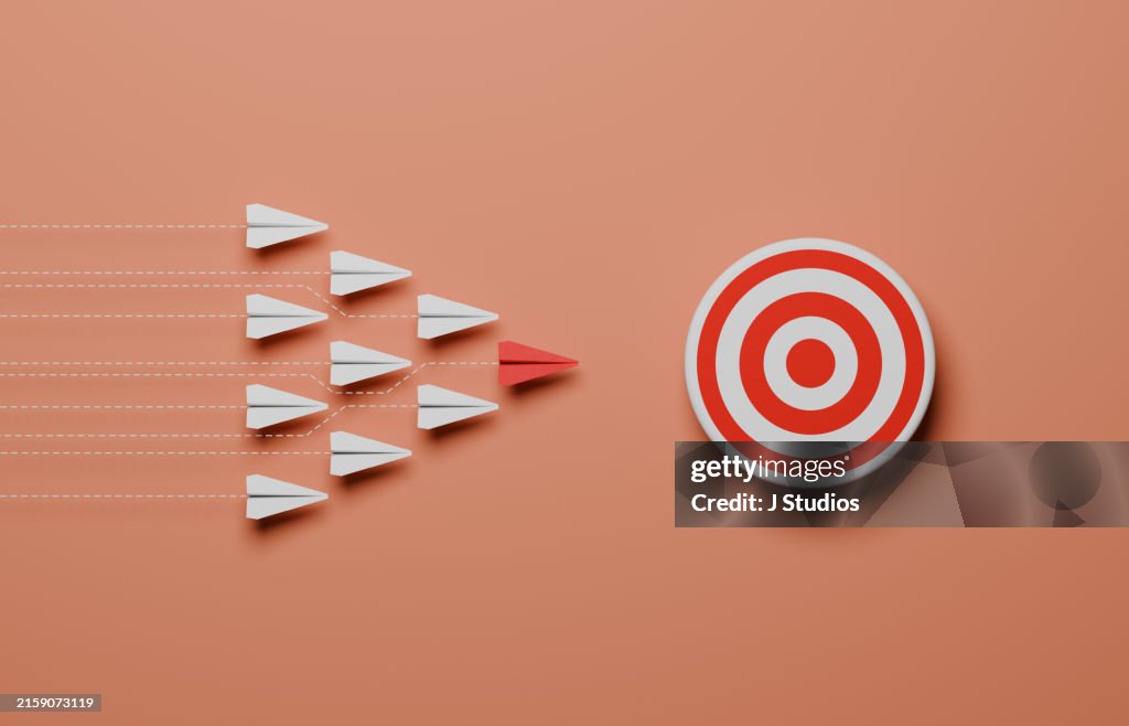 Leader and team of paperplane aiming for a target
