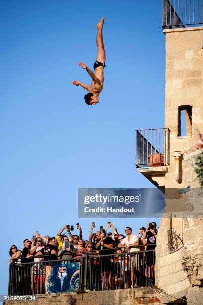 In this handout image provided by Red Bull, Andrea Barnaba of Italy dives from the 26 metre balcony during the first competition day of the third...