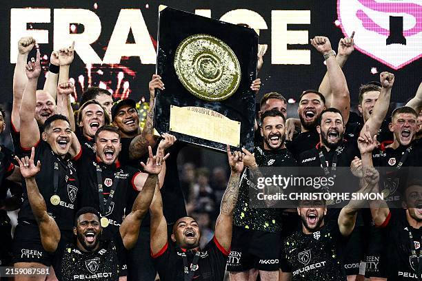 Toulouse's players celebrate with the Bouclier de Brennus trophy after winning the French Top 14 rugby union final match between the Stade Toulousain...