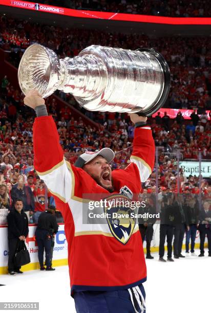 Kyle Okposo of the Florida Panthers hoists the Stanley Cup after Game Seven of the 2024 Stanley Cup Final between the Edmonton Oilers and the Florida...