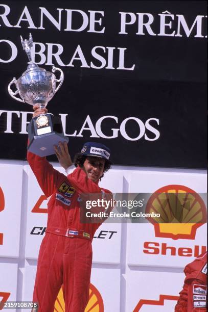 Alain Prost lifts the winner's trophy on the podium during the Brazilian GP at Autódromo José Carlos Pace on March 25, 1990 in Autódromo José Carlos...