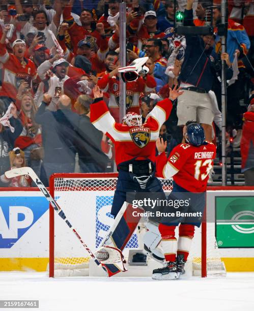 Sergei Bobrovsky and Sam Reinhart of the Florida Panthers celebrate with the Stanley Cup following a 2-1 victory over the Edmonton Oilers in Game...