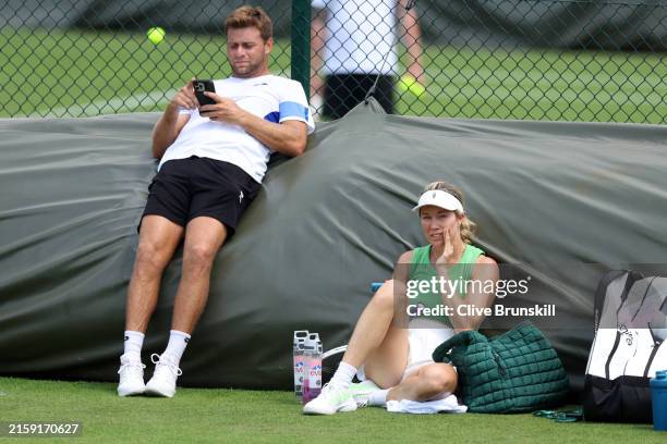 Danielle Collins of United States applies suncream beside former tennis player, Ryan Harrison during practice prior to The Championships Wimbledon...
