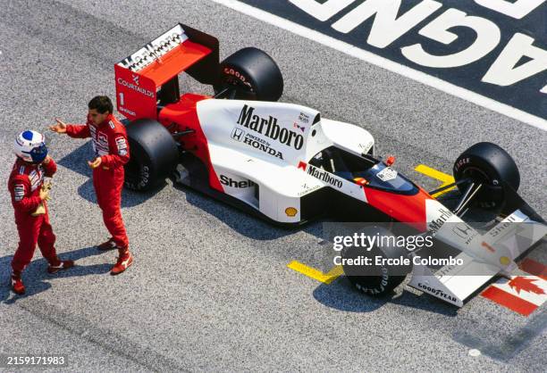 Alain Prost and Ayrton Senna in discussion on the grid next to Senna's McLaren MP4/5 Honda during the San Marino GP at Autodromo Internazionale Enzo...