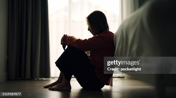 woman depression in bedroom. - distraught stock pictures, royalty-free photos & images