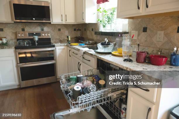 cluttered kitchen - microwave mess stock pictures, royalty-free photos & images