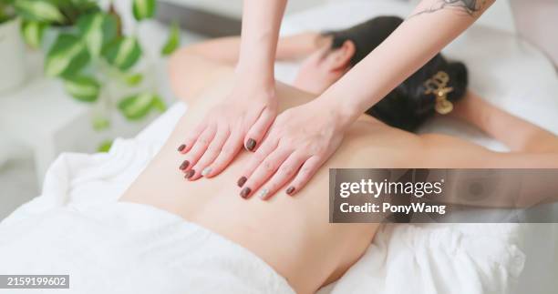 asian masseurs massage client back - hand patting stock pictures, royalty-free photos & images