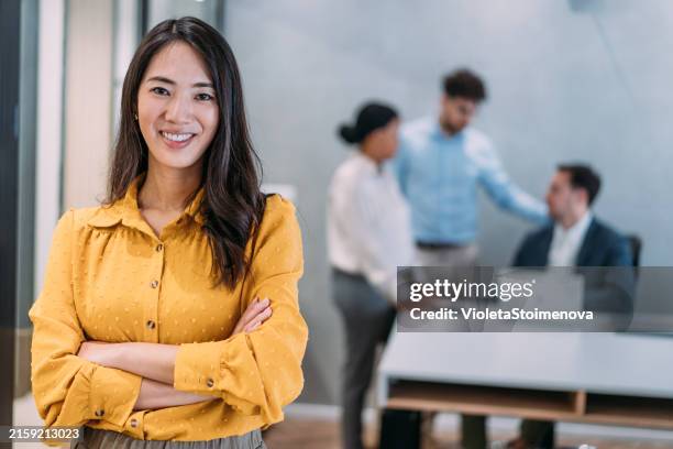 successful businesswoman in the office. - asian females stock pictures, royalty-free photos & images