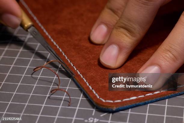 beveling cutting edge on the brown leather stripe - awl stock pictures, royalty-free photos & images