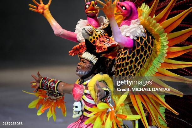 Members of the Boi Bumba Garantido association perform during the Boi Bumba folklore festival at the Bumbodromo in Parintins, Amazonas State, Brazil,...