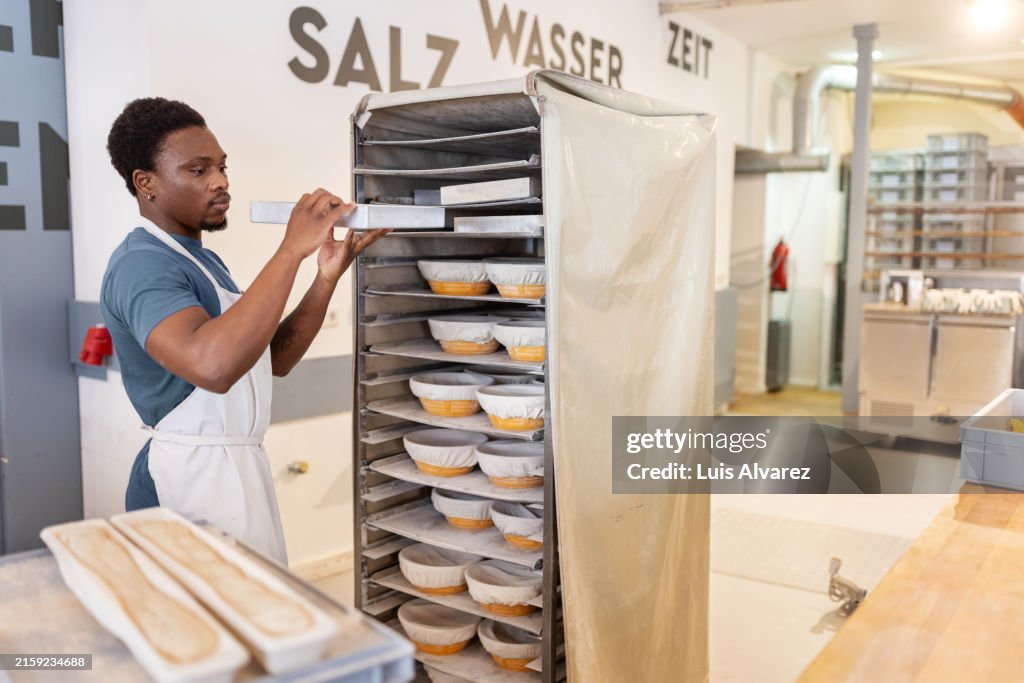 Young african man working in bakery workshop