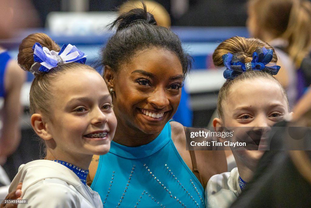 Simone Core Simone Biles during poses for a photograph with young gymnasts after ...