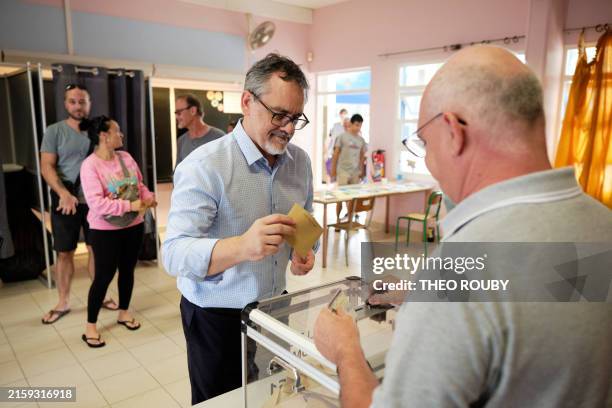 Outgoing French MP Philippe Dunoyer casts his ballot to vote in the first round of France's crunch legislative elections at a polling station in the...