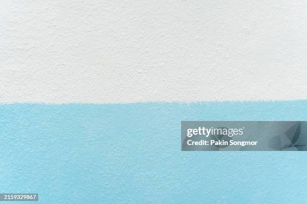 blue paint on a white painted, patinated and scratched cement wall. close-up of the facade of a building - blue and turquoise stock pictures, royalty-free photos & images