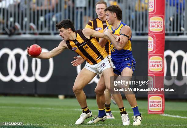 Massimo D'Ambrosio of the Hawks is tackled by Campbell Chesser of the Eagles during the 2024 AFL Round 16 match between the West Coast Eagles and the...